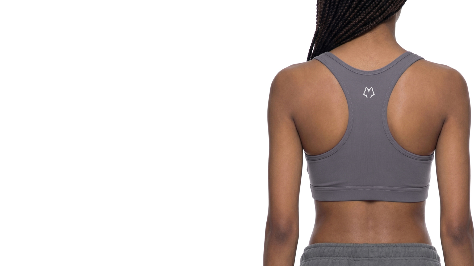 Woman wearing Carbon Wolf sports bra and sweatpants, back view